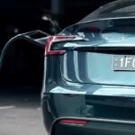 Close-up of an electric car charging at a station, showcasing modern sustainability.