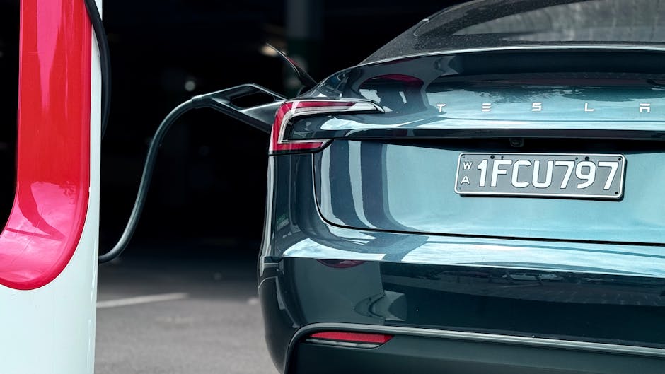 Close-up of an electric car charging at a station, showcasing modern sustainability.